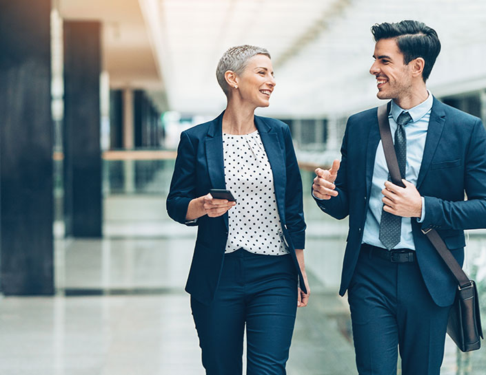 Two business people walking together
